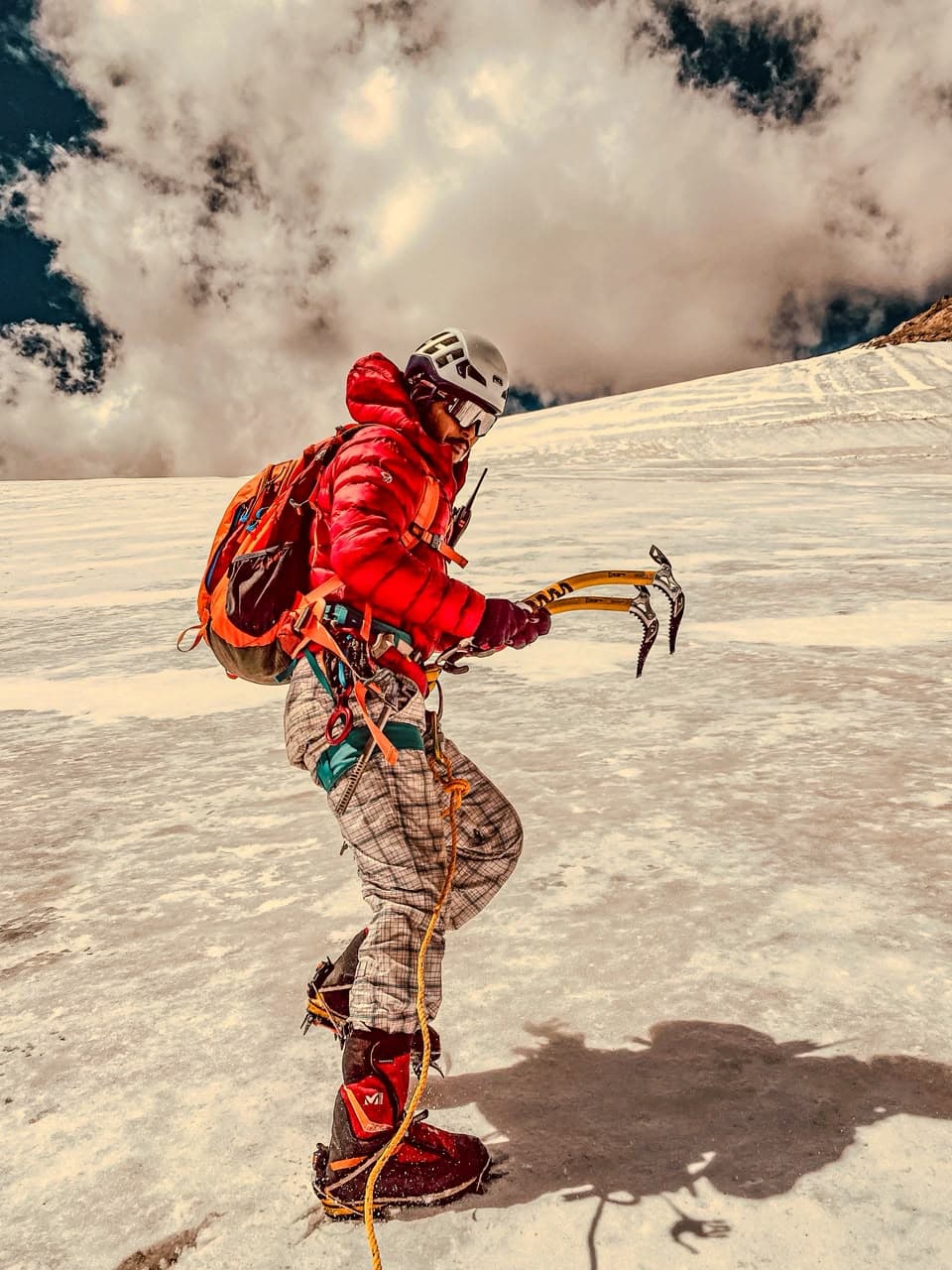 Ricky Mountaineer climbing on snow and ice with technical axes