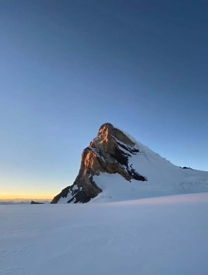 Snow-covered Mount Kun rising above a glacier at sunrise in Ladakh
